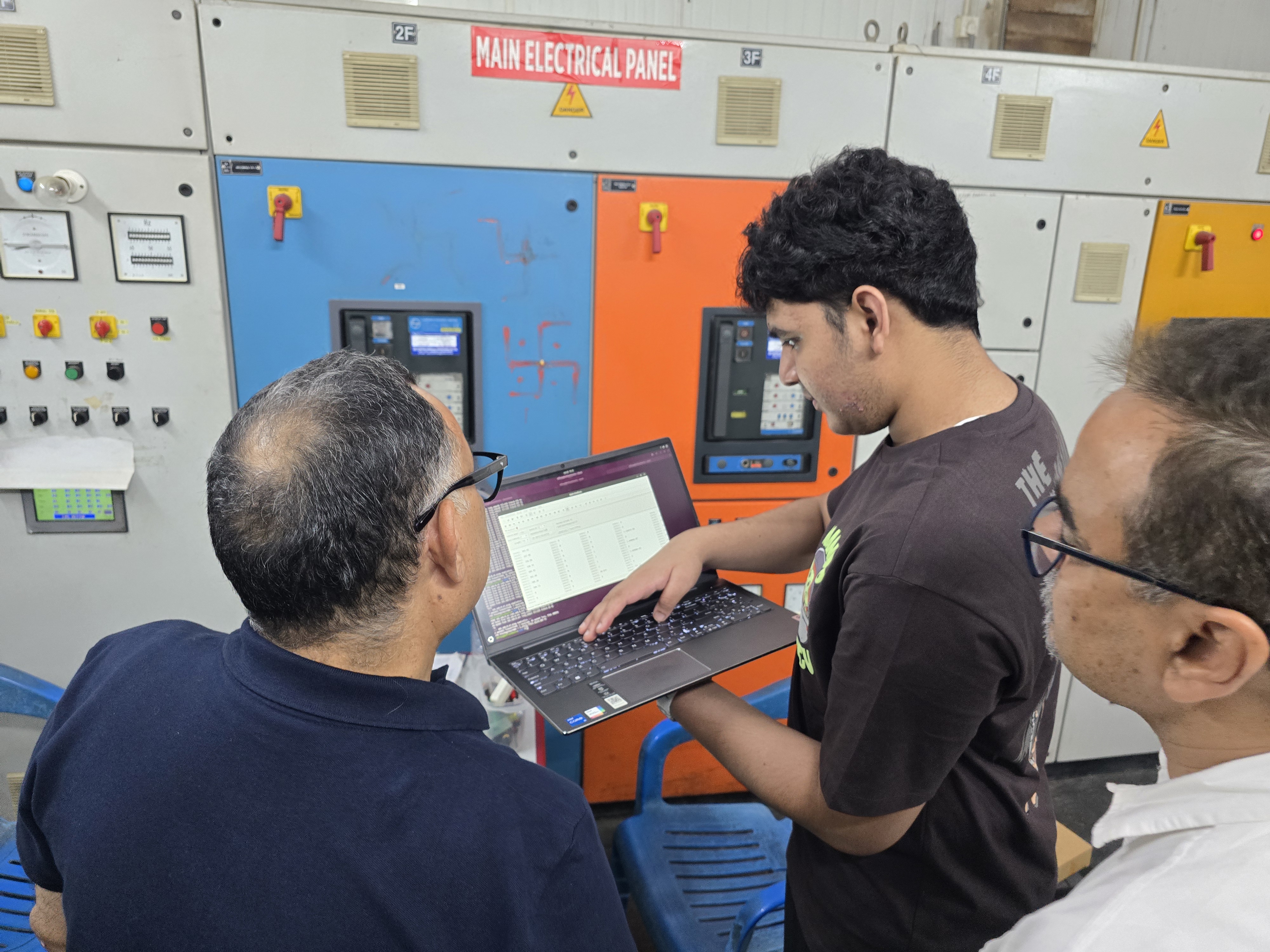 Aditya walking two adults through live AeiX data at the TSRS main electrical panel