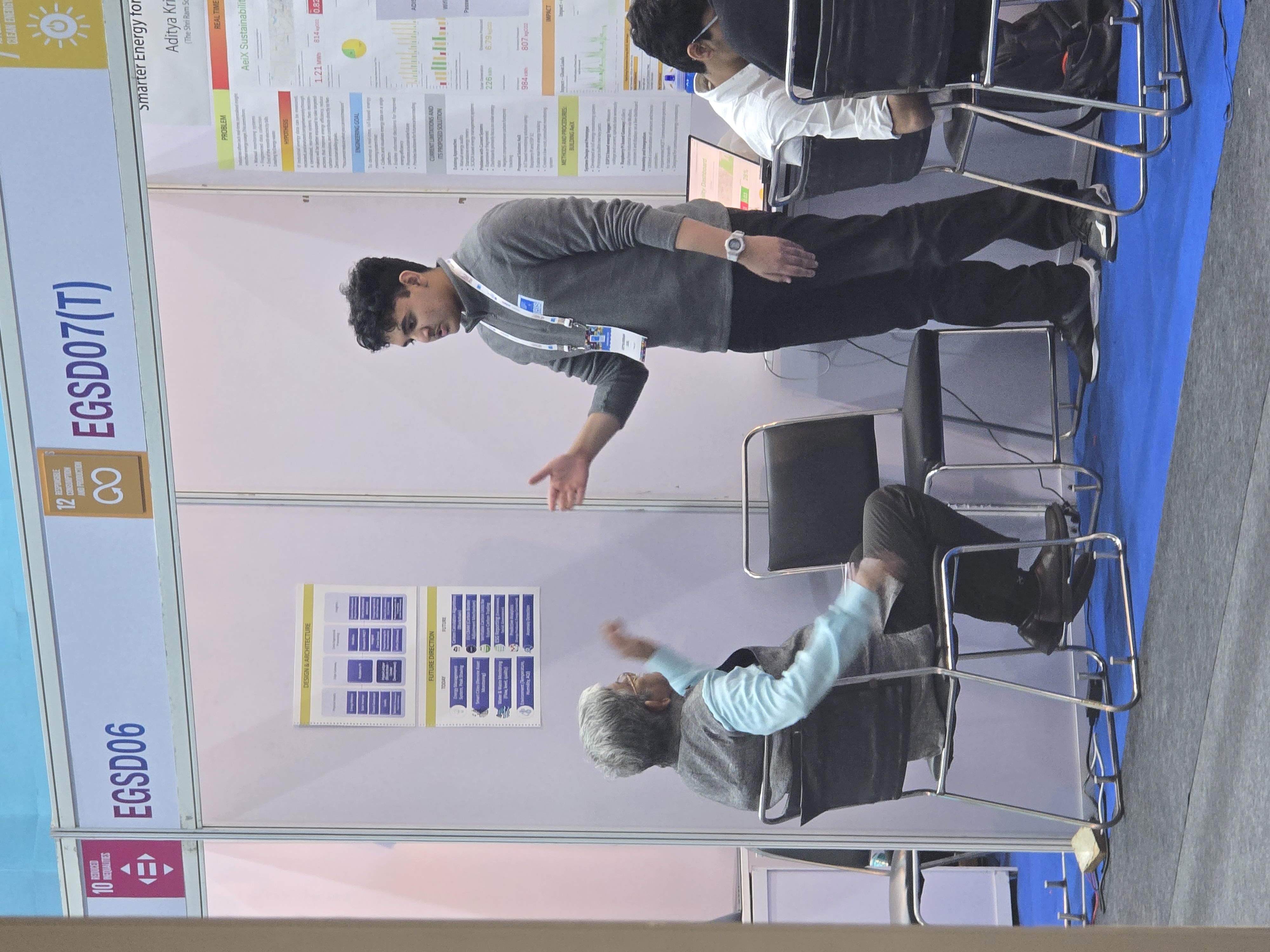 Presenting the AeiX project to a judge at the IRIS Fair booth