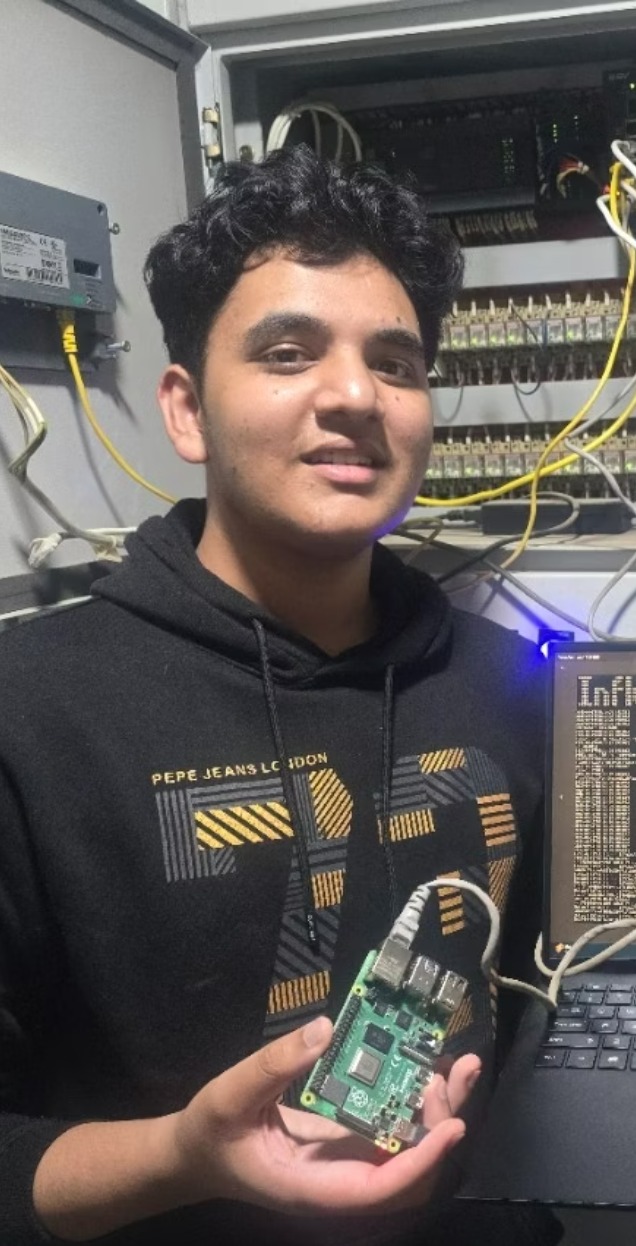 Aditya at the Sakkatech electrical panel holding the AeiX Raspberry Pi gateway