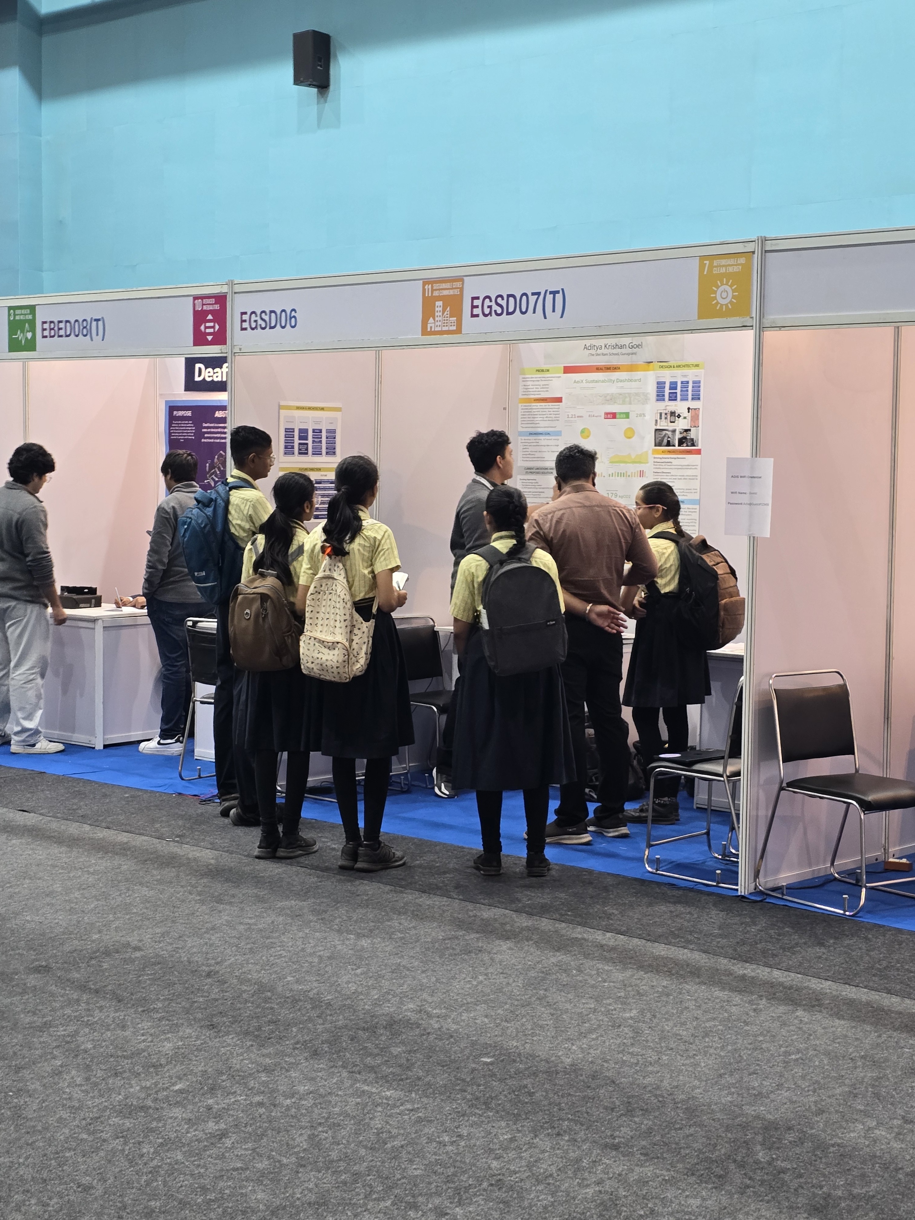 A crowd of students gathered at the AeiX poster booth at IRIS