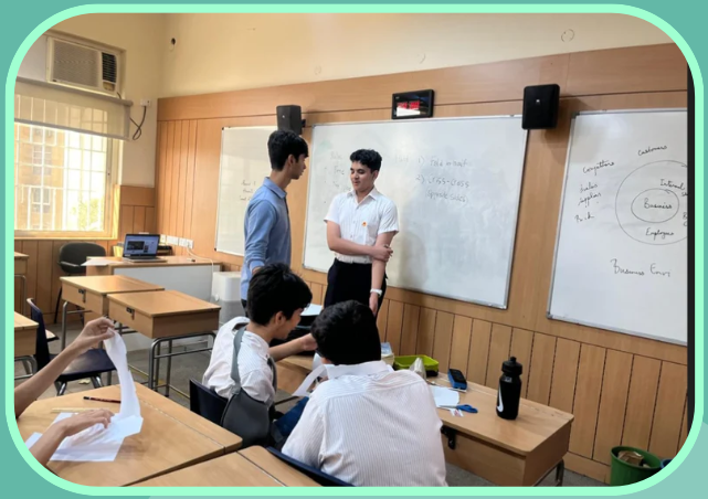 Leading a Maths & Puzzles Society session at the whiteboard